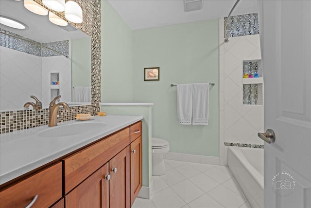 585 Apache Dr, Batavia, IL 60510 - bathroom featuring tile patterned floors, toilet, baseboards, vanity, and tasteful backsplash