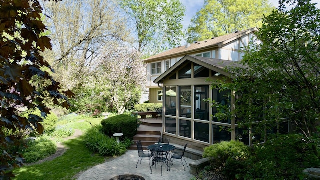 585 Apache Dr, Batavia, IL 60510 - rear view of property featuring a sunroom and a patio