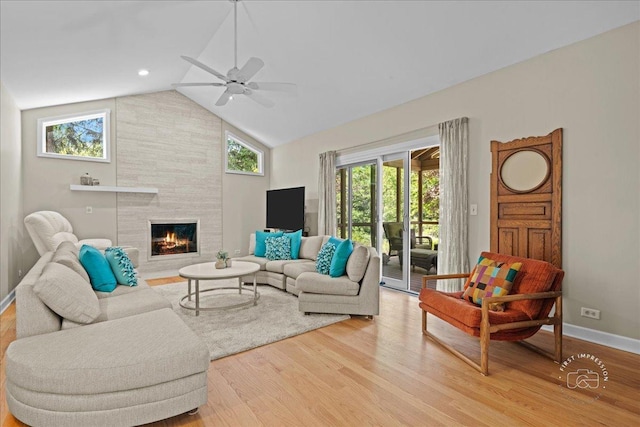 585 Apache Dr, Batavia, IL 60510 - living room with light wood-style flooring, lofted ceiling, ceiling fan, a tile fireplace, and baseboards