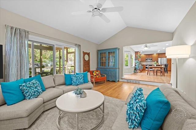 585 Apache Dr, Batavia, IL 60510 - living area with a ceiling fan, light wood-style flooring, healthy amount of natural light, and high vaulted ceiling