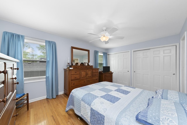 1557 Swallow St, Naperville, IL 60565 - bedroom with baseboards, light wood-style floors, two closets, and multiple windows