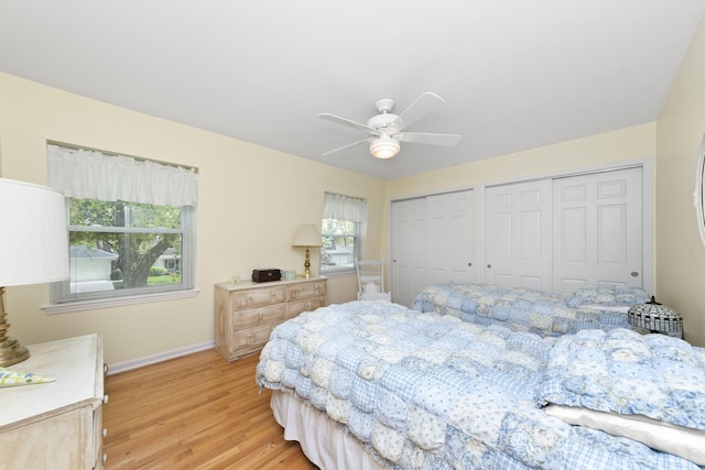 1557 Swallow St, Naperville, IL 60565 - bedroom with multiple closets, light wood finished floors, baseboards, and ceiling fan