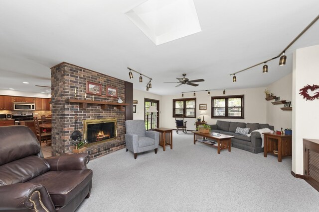 1557 Swallow St, Naperville, IL 60565 - living area with track lighting, a brick fireplace, light carpet, and a skylight