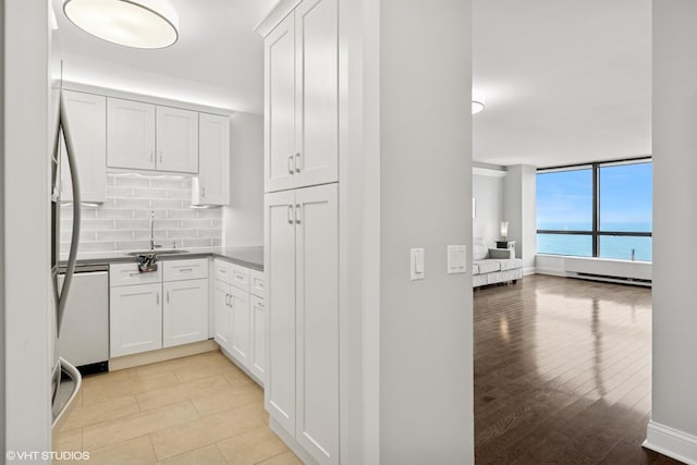 5415 N Sheridan Rd Unit 3004, Chicago, IL 60640 - kitchen featuring a sink, open floor plan, dishwasher, tasteful backsplash, and white cabinets