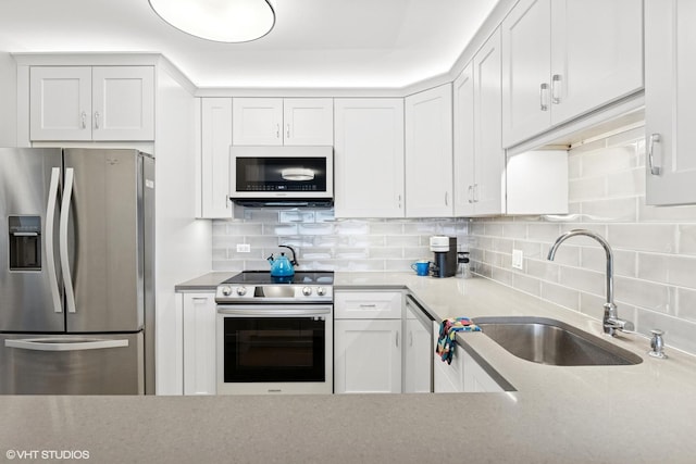 5415 N Sheridan Rd Unit 3004, Chicago, IL 60640 - kitchen featuring stainless steel appliances, a sink, tasteful backsplash, and white cabinets