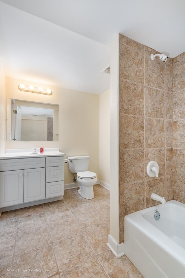 bathroom featuring tile patterned floors, toilet, shower / tub combination, vanity, and baseboards
