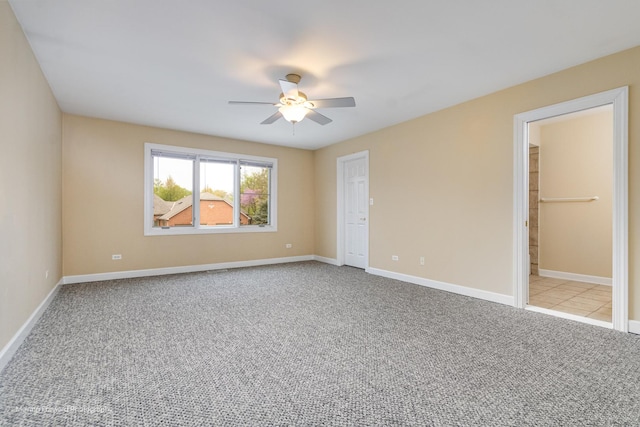 unfurnished bedroom featuring carpet flooring, baseboards, and ceiling fan