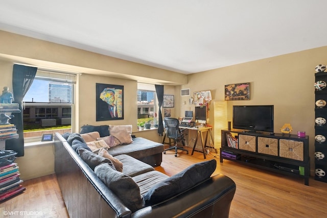 living room with wood finished floors and a desk