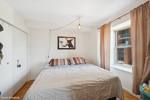 bedroom featuring light wood-style flooring and a closet