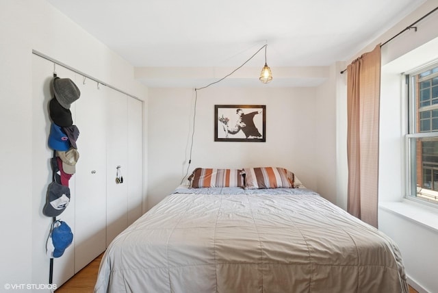 bedroom featuring a closet and wood finished floors