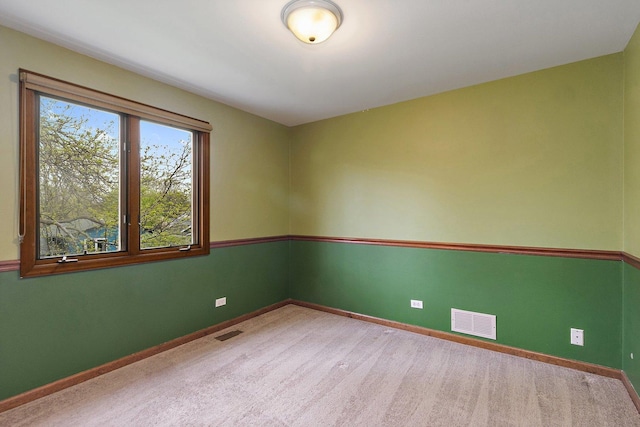 carpeted empty room with baseboards