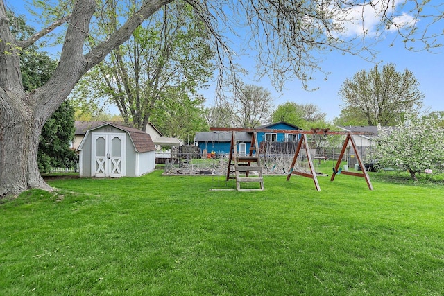 view of yard featuring a playground, a storage shed, and an outdoor structure