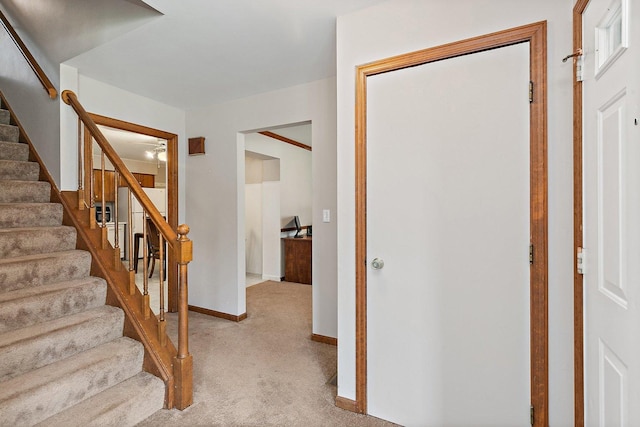 staircase with baseboards and carpet floors