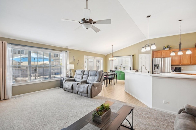 10409 Evendale Dr, Huntley, IL 60142 - living room with a ceiling fan, light carpet, a chandelier, vaulted ceiling, and baseboards