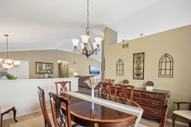 10409 Evendale Dr, Huntley, IL 60142 - dining space with a chandelier, vaulted ceiling, wood finished floors, and baseboards