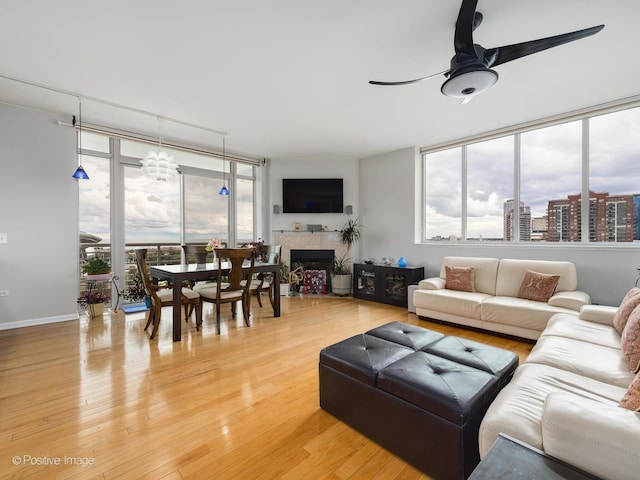 1515 S Prairie Ave Unit 1306, Chicago, IL 60605 - living room with a ceiling fan, a wall of windows, a tiled fireplace, and light wood-style floors