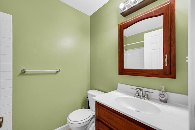 full bath with toilet, vanity, and a shower