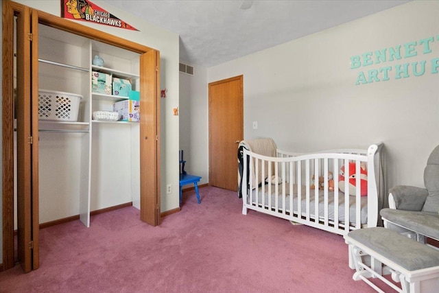 carpeted bedroom with a crib, a closet, and visible vents