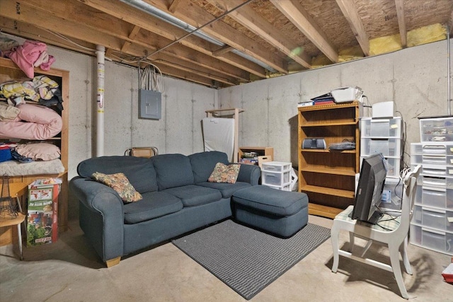 living area with concrete floors and electric panel