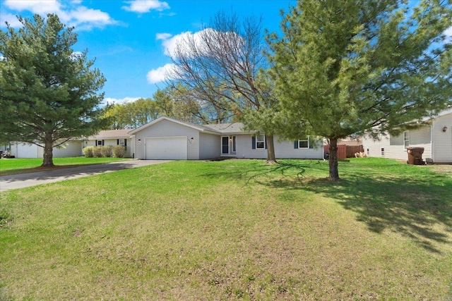 ranch-style home featuring driveway, a garage, and a front yard