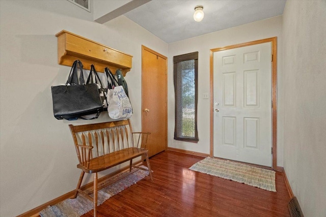 entryway with baseboards and wood finished floors