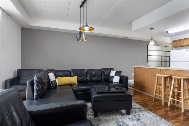 2734 S Wentworth Ave Unit 317, Chicago, IL 60616 - living room with dark wood-style flooring, a tray ceiling, and indoor wet bar