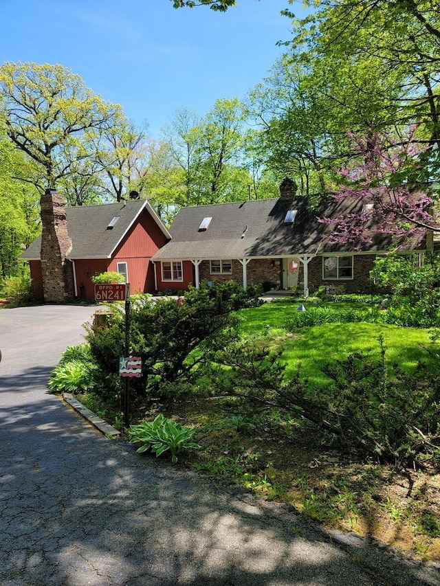 6N241 Roselle Rd, Roselle, IL 60172 - view of front of house with a chimney and concrete driveway