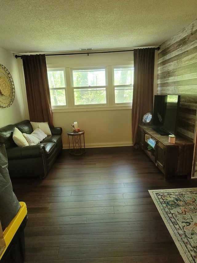 6N241 Roselle Rd, Roselle, IL 60172 - living room with a textured ceiling, dark wood-type flooring, wood walls, and baseboards