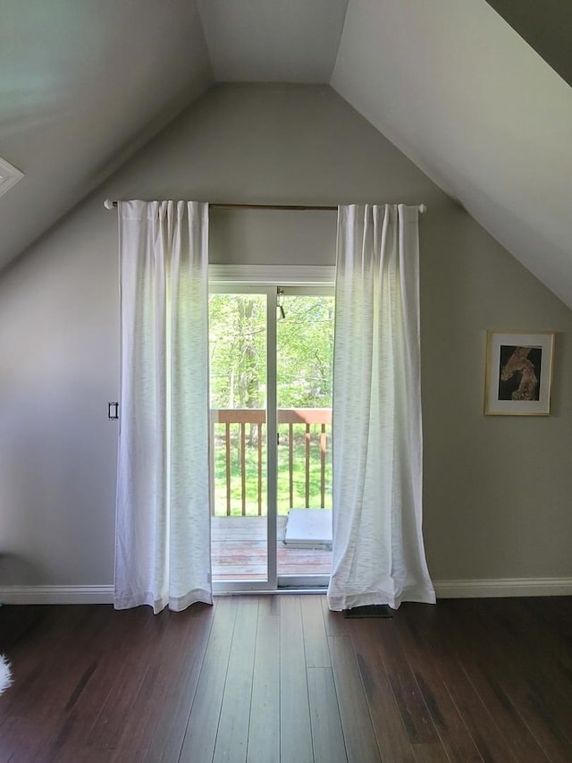 6N241 Roselle Rd, Roselle, IL 60172 - additional living space featuring vaulted ceiling, dark wood-type flooring, and baseboards