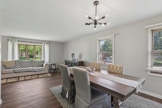 dining room with a chandelier and dark wood-style flooring