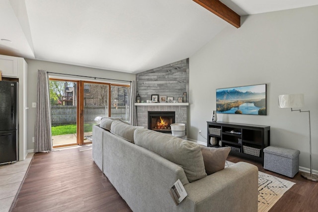 living room featuring a fireplace, baseboards, wood finished floors, beam ceiling, and high vaulted ceiling