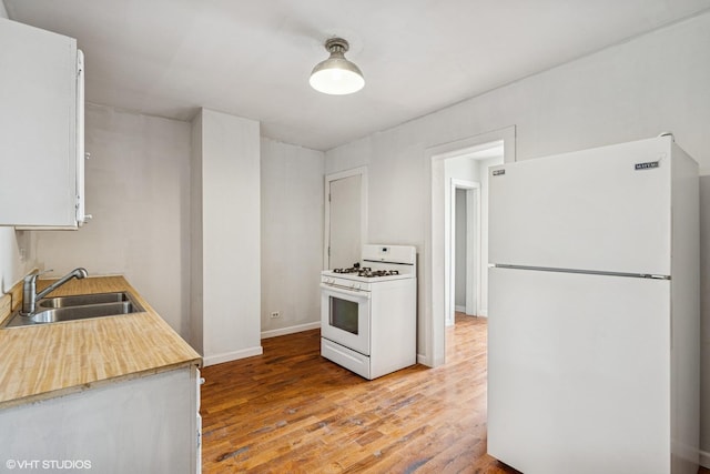 1751 W 21st Pl, Chicago, IL 60608 - kitchen with white appliances, a sink, light wood finished floors, light countertops, and white cabinets