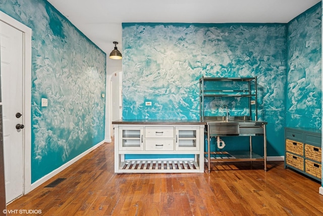 1751 W 21st Pl, Chicago, IL 60608 - misc room featuring wallpapered walls, hardwood / wood-style floors, baseboards, and a sink