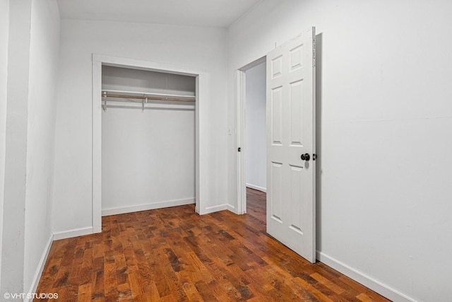 1751 W 21st Pl, Chicago, IL 60608 - unfurnished bedroom with a closet, wood finished floors, and baseboards