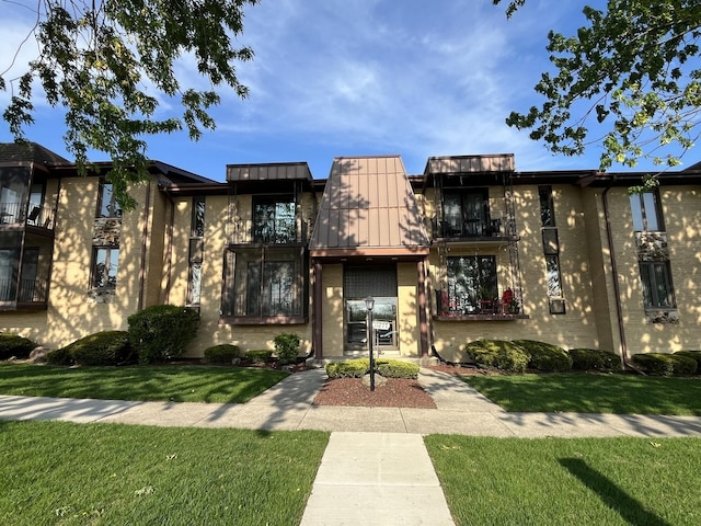 11277 S Roberts Rd Unit G, Palos Hills, IL 60465 - view of property with a front yard, a standing seam roof, and a balcony