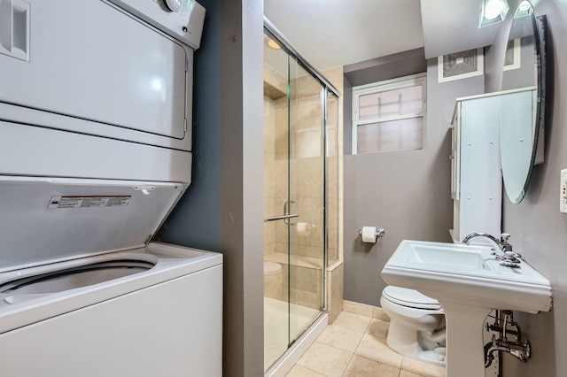 2241 N Lincoln Ave Unit 1A, Chicago, IL 60614 - full bathroom with stacked washing machine and dryer, toilet, a stall shower, and tile patterned flooring
