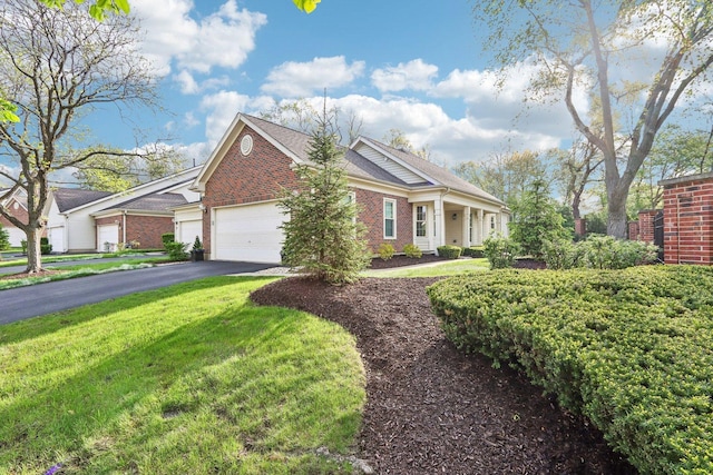 316 Spring Creek Cir, Schaumburg, IL 60173 - view of front of house with brick siding, an attached garage, driveway, and a front yard