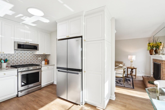 316 Spring Creek Cir, Schaumburg, IL 60173 - kitchen with stainless steel appliances, white cabinetry, light wood finished floors, and tasteful backsplash