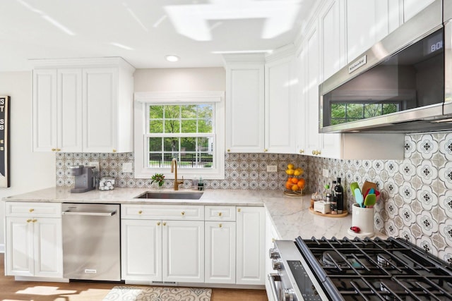 316 Spring Creek Cir, Schaumburg, IL 60173 - kitchen featuring appliances with stainless steel finishes, a sink, white cabinets, light stone counters, and backsplash