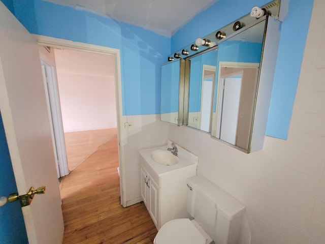 1227 S Harlem Ave Unit 208, Berwyn, IL 60402 - half bath featuring vanity, toilet, and wood finished floors