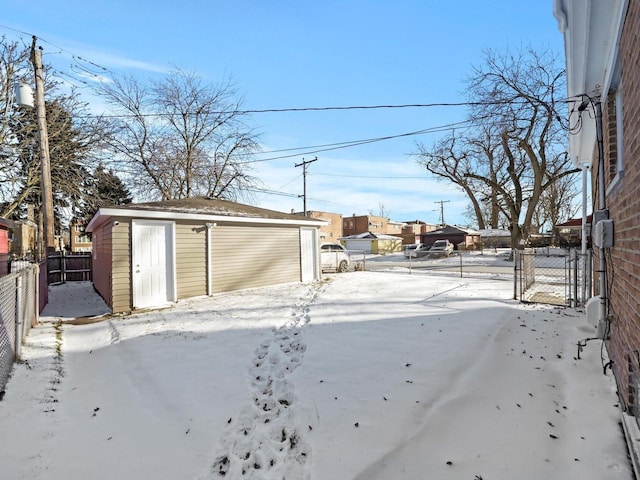 417 Oglesby Ave, Calumet City, IL 60409 - yard covered in snow featuring an outbuilding, a storage shed, and a fenced backyard