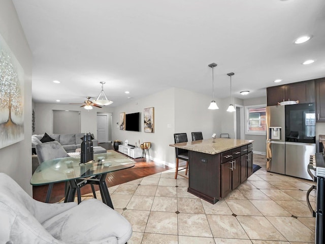 417 Oglesby Ave, Calumet City, IL 60409 - kitchen with pendant lighting, stainless steel refrigerator with ice dispenser, open floor plan, dark brown cabinetry, and recessed lighting