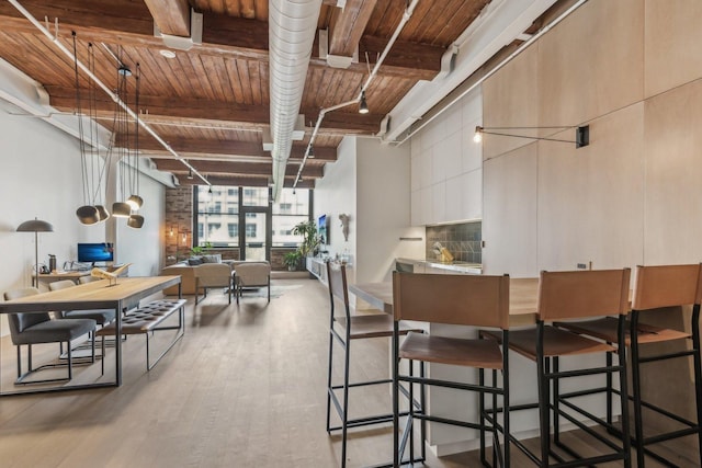 dining area featuring wood ceiling, wood finished floors, beam ceiling, and an office area