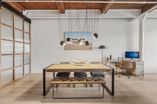office space with wood finished floors, beamed ceiling, and baseboards