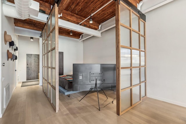 office featuring wooden ceiling, wood finished floors, beamed ceiling, french doors, and baseboards