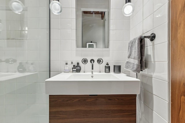 bathroom featuring tile walls, vanity, and backsplash