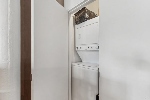 washroom featuring stacked washing machine and dryer