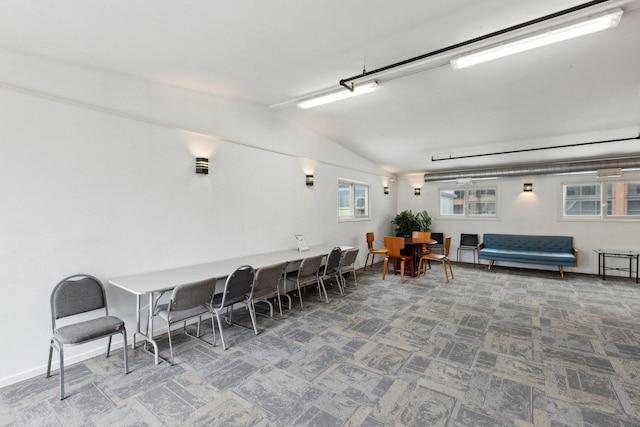 dining area with vaulted ceiling, carpet floors, and baseboards