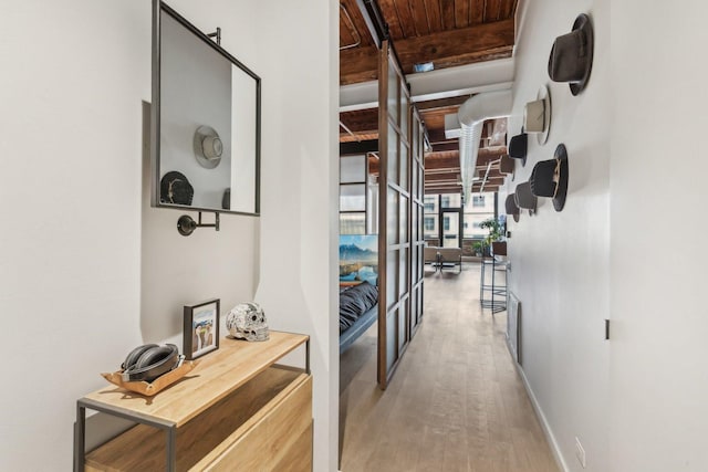 corridor with wood finished floors, french doors, wood ceiling, baseboards, and beamed ceiling