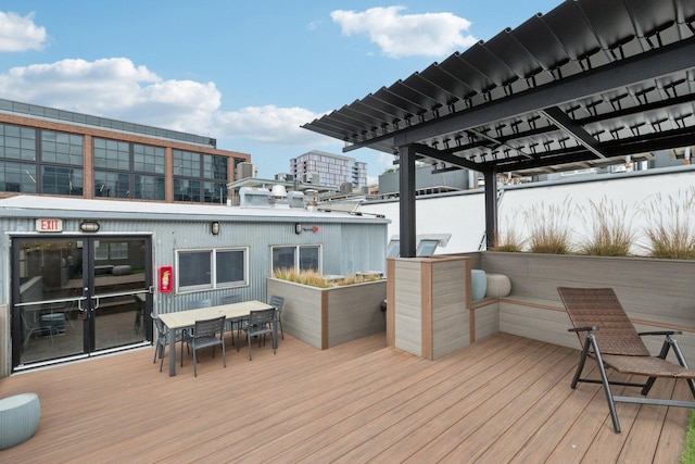 wooden terrace featuring outdoor dining space and a pergola